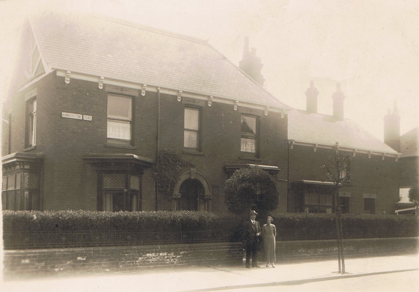 Ralph’s parents outside their house