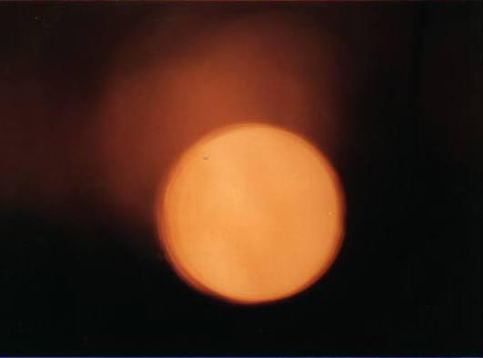 [Picture of a large orange ball hovering in smoky blackness.] Seriously, folks, this *isn't* a fake!